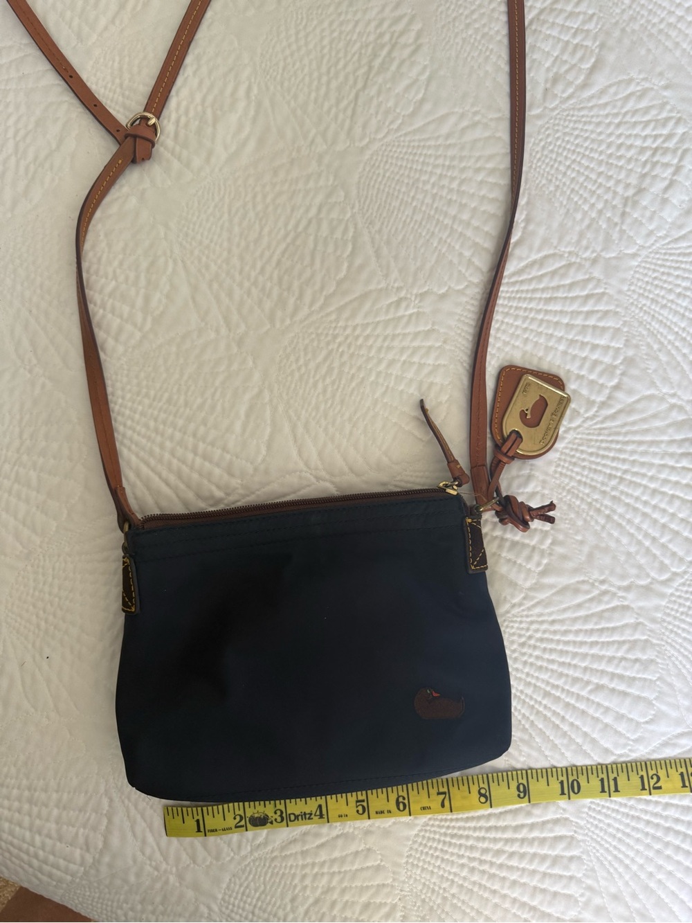 Dooney & Bourke Navy Nylon Crossbody with Brown Leather strap.